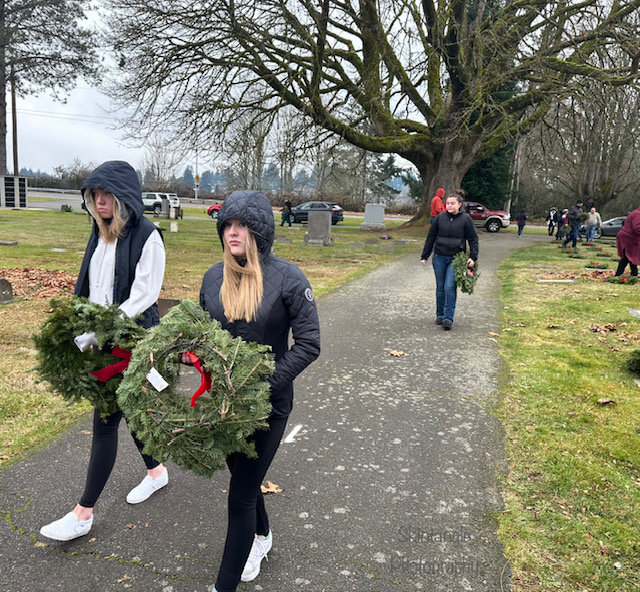 Each volunteer walks to choose a service member’s grave for their wreath.